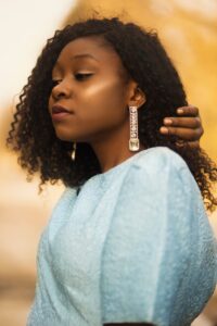 woman touching her hair selective focal photo