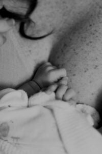 newborn hands on mother skin
