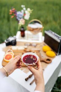 woman hands holding tea cup on picnic