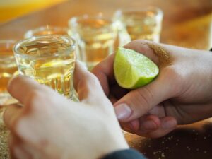 a person having a tequila shot