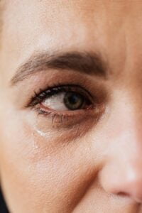 tearful eye of upset middle aged woman