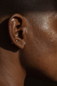 cheek and piercing in ear of crop black woman